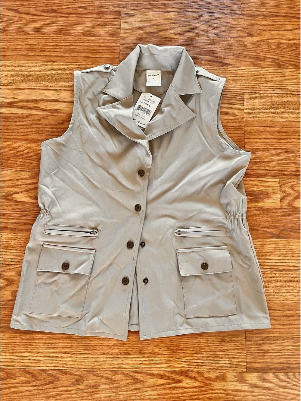 Tan sleeveless Girl Scouts vest. Size Teen Small. NWT
